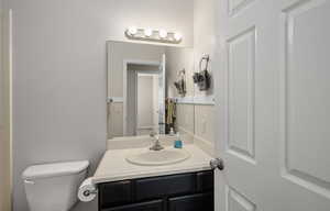 Half bath featuring vanity and toilet