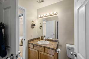 Ensuite bathroom featuring toilet and vanity