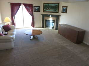 Family room  area with carpet floors and a gas fireplace