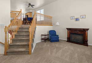 Staircase featuring carpet, ceiling fan