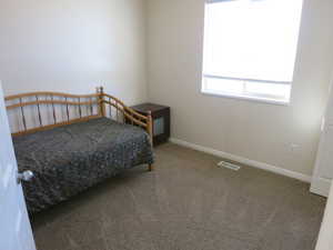 Bedroom featuring light colored carpet and baseboards