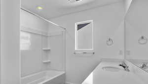 Full bathroom featuring vanity and shower / bath combination