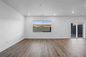 Unfurnished room featuring wood finished floors and recessed lighting