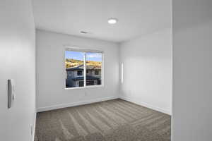 Empty room with carpet flooring and baseboards