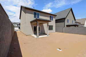 Back of property featuring a patio area, stucco siding, and a fenced backyard