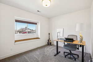 Home office with carpet and baseboards
