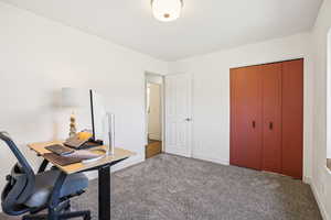 Carpeted home office with baseboards