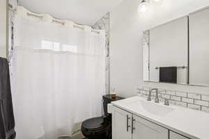 Full bath with toilet and vanity