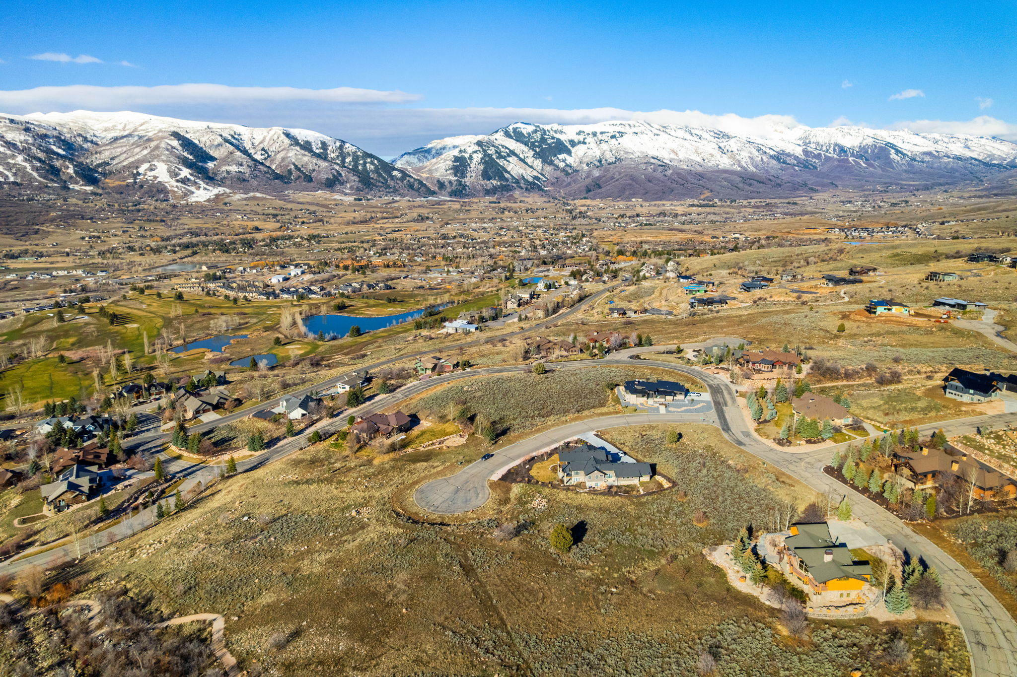 Aerial overview of property's location with nearby suburban area and a water and mountain view