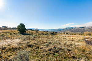 View of mountain backdrop featuring rural landscape
