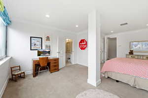 Bedroom featuring light colored carpet, ornamental molding, a desk, and recessed lighting