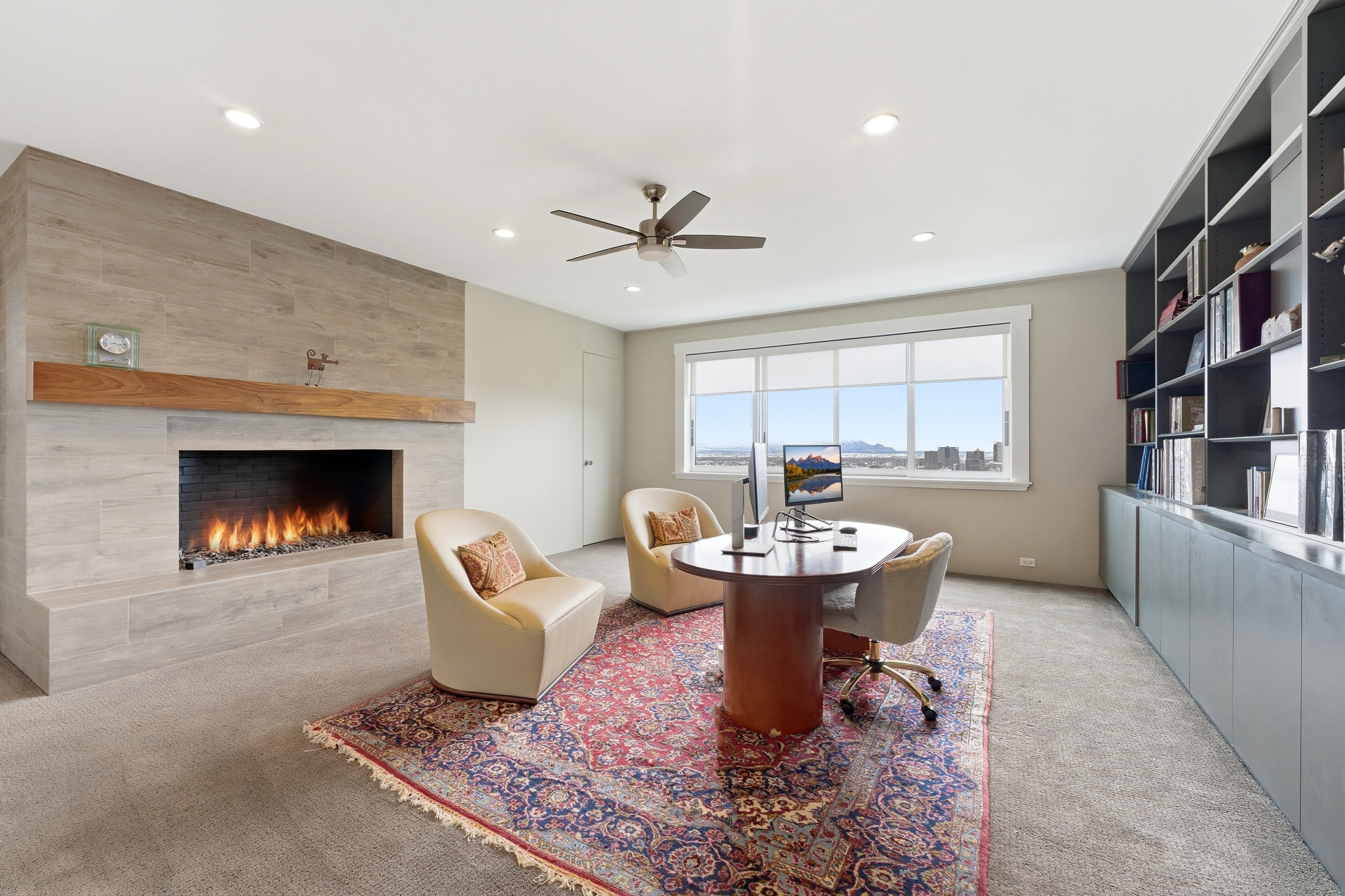 Sitting room featuring light carpet, a fireplace, ceiling fan, recessed lighting, and a desk