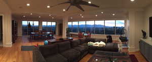 Living room featuring light wood-style flooring, a ceiling fan, recessed lighting, and healthy amount of natural light