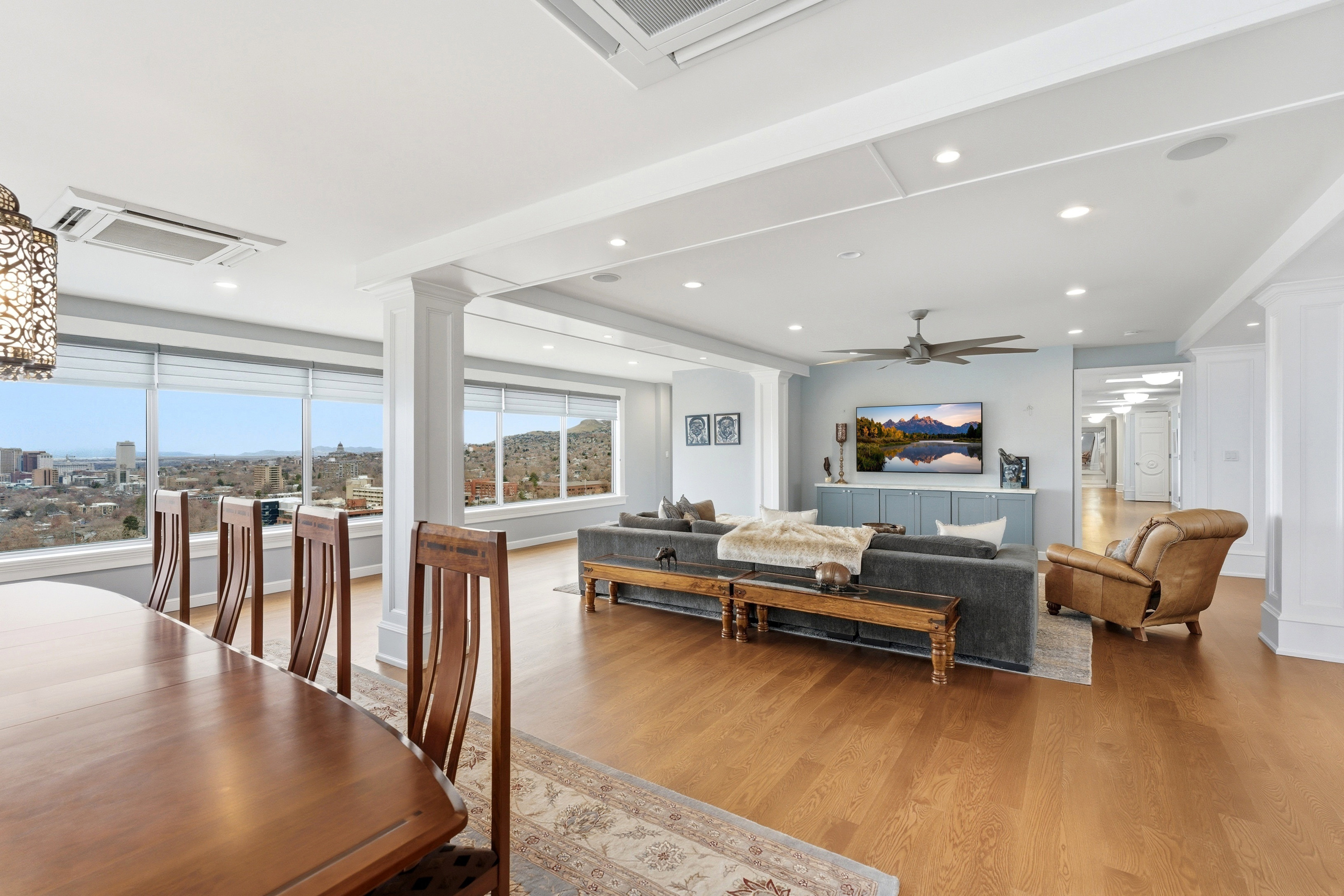 Living area with decorative columns, light wood-style flooring, and recessed lighting
