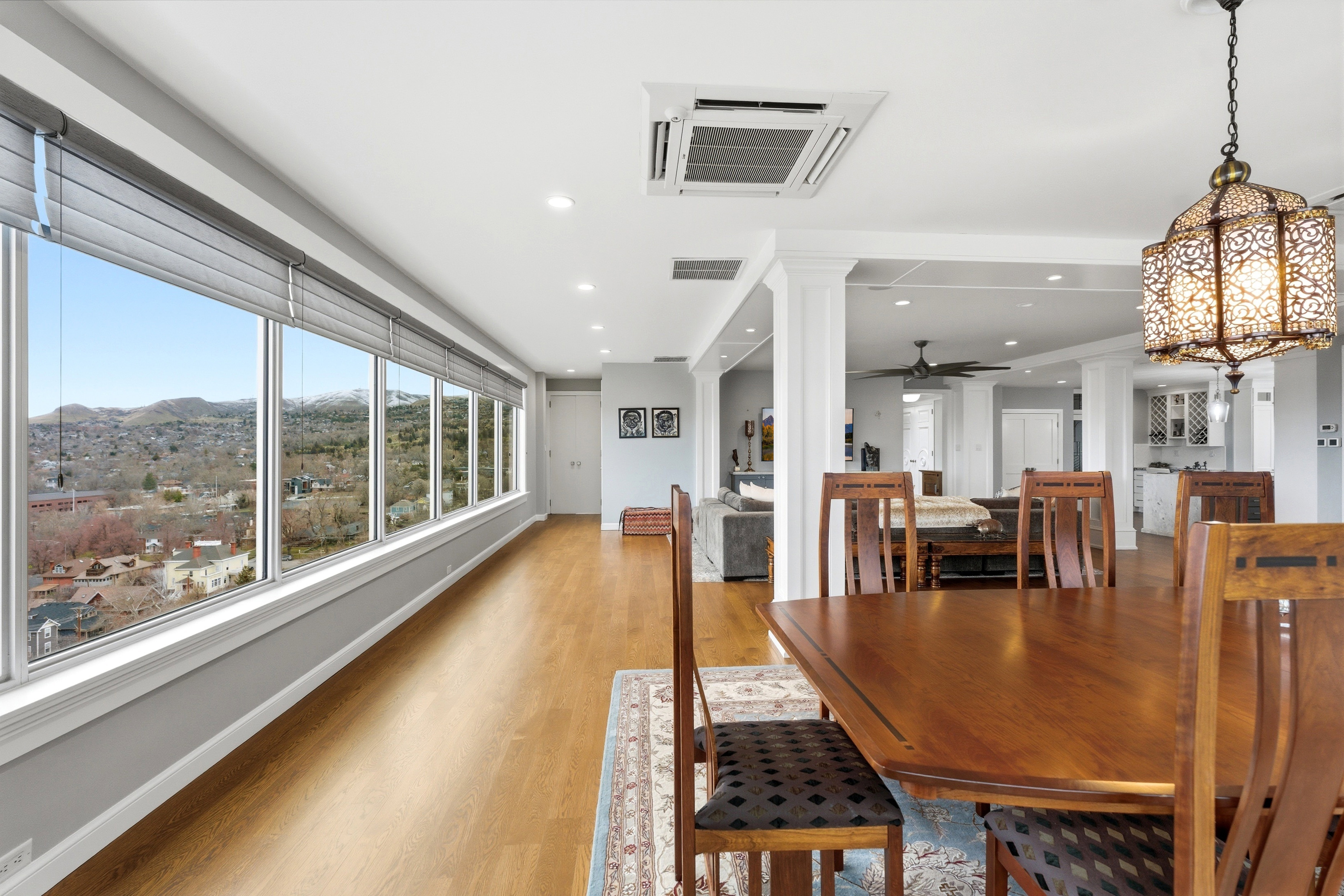 Dining room featuring ornate columns, light wood finished floors, a mountain view, recessed lighting, and ceiling fan