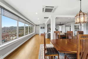 Dining room featuring ornate columns, light wood finished floors, a mountain view, recessed lighting, and ceiling fan