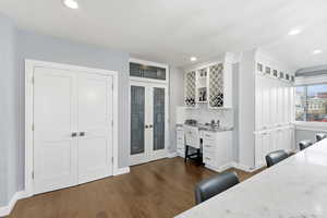 Office featuring dark wood-style flooring, french doors, and recessed lighting