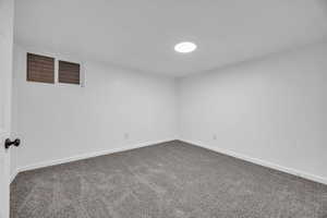 Unfurnished room with baseboards and carpet