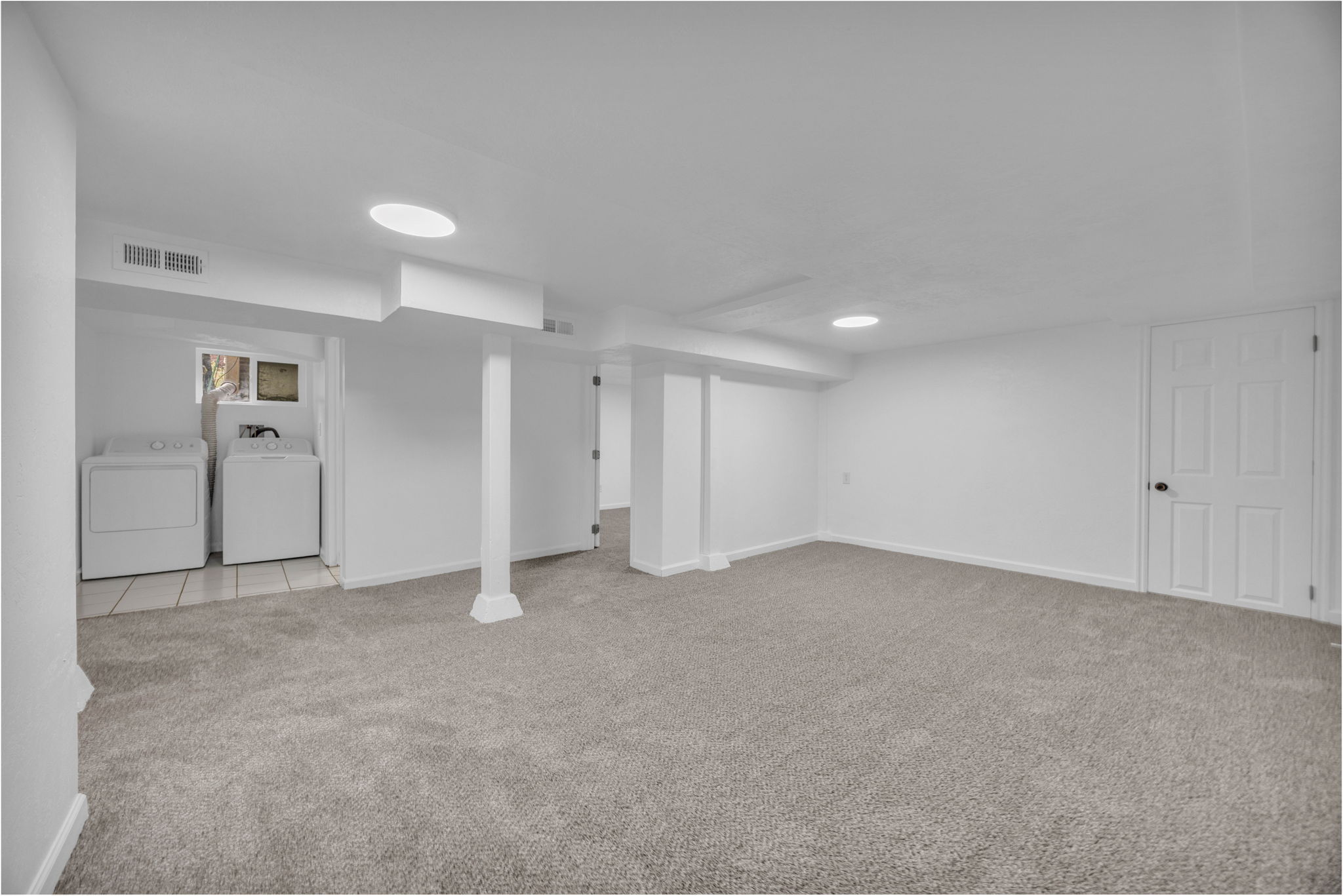 Finished basement with independent washer and dryer and light carpet