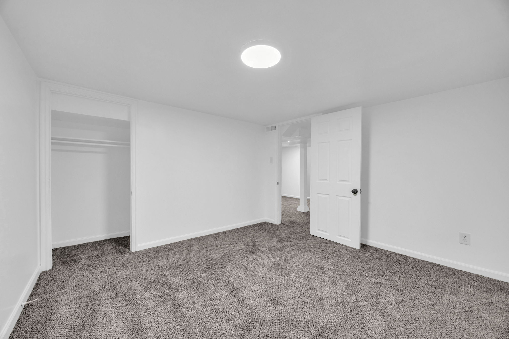 Unfurnished bedroom featuring carpet flooring and a closet
