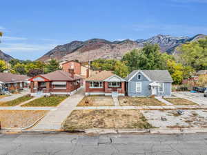 Bungalow-style house with a mountain view, brick siding, and a shingled roof