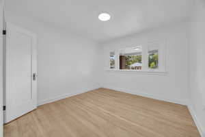 Spare room with light wood finished floors and baseboards