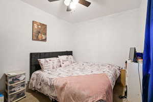 Carpeted bedroom with ceiling fan