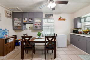 Dining area featuring ceiling fan and light tile patterned flooring
