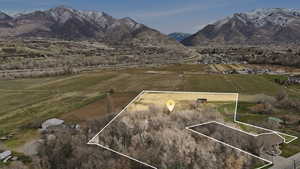 View of rural area featuring property parcel outlined, mountains, and large plots for crops