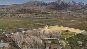 Overview of rural landscape with property boundaries highlighted and a mountain backdrop