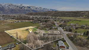 Overview of rural landscape featuring property parcel outlined and a mountain backdrop