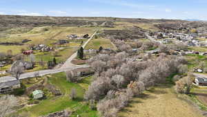 Aerial view of property and surrounding area with nearby suburban area