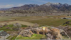 Aerial view of sparsely populated area featuring property boundaries highlighted and mountains