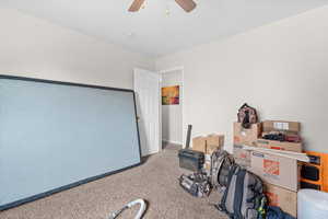 Recreation room featuring a ceiling fan and carpet
