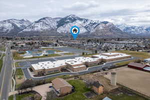 Aerial View – Nearby Schools & Recreation – Aerial view highlighting the home’s location within the neighborhood with North Ogden Elementary School in the foreground and Loren Farr Pool and aquatic center just across the street, all set against the
