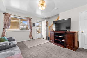 Living room with light carpet and ceiling fan