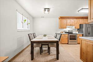 Dining area featuring light tile patterned flooring and baseboards