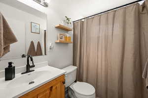 Full bath with vanity and a shower with curtain