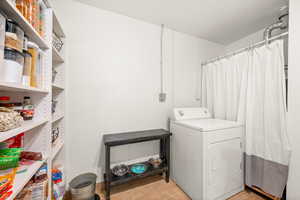 Laundry room featuring washer / clothes dryer and light tile patterned floors