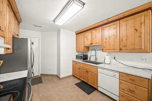 Kitchen with light countertops and stainless steel appliances