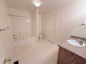 Bathroom with vanity, tub / shower combination, and a textured ceiling