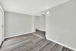 Spare room with light wood-style floors and baseboards
