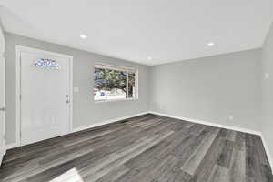 Foyer featuring dark wood-style flooring and recessed lighting
