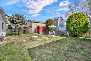 Fenced backyard featuring a patio and a storage shed