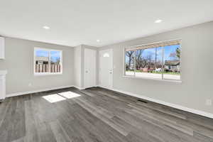 Unfurnished living room featuring wood finished floors, recessed lighting, and a textured ceiling