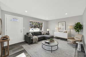 Living room with wood finished floors and recessed lighting