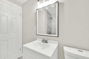 Bathroom featuring vanity and a shower