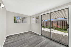 Spare room featuring baseboards and wood finished floors