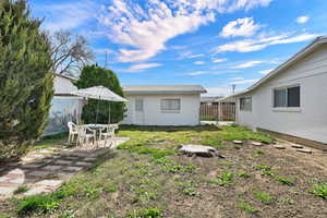 Fenced yard featuring outdoor dining area and a patio area