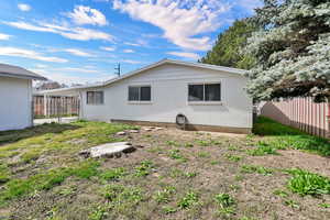 Rear view of property with brick siding